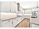 Modern kitchen featuring a gas cooktop, stainless steel appliances, white cabinets, and a kitchen island at 17165 W Piperton St # 181, Surprise, AZ 85388