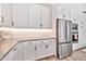 Beautiful kitchen with stainless steel appliances, white cabinets, and stylish countertops at 17165 W Piperton St # 181, Surprise, AZ 85388