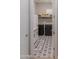 Functional laundry room with modern washer and dryer, stylish flooring, and ample cabinet space at 17165 W Piperton St # 181, Surprise, AZ 85388
