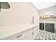 This laundry room features modern appliances, ample counter space, stylish flooring, and great natural light at 17165 W Piperton St # 181, Surprise, AZ 85388