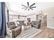 Open concept living area with a ceiling fan, comfortable seating, and a view of the modern kitchen at 17165 W Piperton St # 181, Surprise, AZ 85388