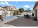 Charming backyard patio featuring pavers, a dining table, and a blue umbrella at 17286 W Morning Glory St, Goodyear, AZ 85338