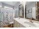 Clean bathroom featuring double sinks, tile floors and a shower with a glass enclosure at 17286 W Morning Glory St, Goodyear, AZ 85338