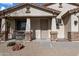 Inviting front porch with stone accents and a cozy seating area, perfect for relaxing outdoors at 17286 W Morning Glory St, Goodyear, AZ 85338