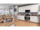 Stylish kitchen featuring stainless steel appliances and granite countertops with white cabinetry at 17286 W Morning Glory St, Goodyear, AZ 85338