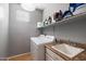 Practical laundry room featuring a washing machine and dryer set, and a utility sink at 17286 W Morning Glory St, Goodyear, AZ 85338