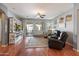 Bright and airy living room with wood floors, and sliding glass doors to patio at 17286 W Morning Glory St, Goodyear, AZ 85338