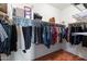 Well-organized walk-in closet with shelving and rods for hanging clothes at 17286 W Morning Glory St, Goodyear, AZ 85338