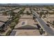 Aerial view of home featuring rooftop solar panels, a tile roof, and a golf course in the distance at 1775 E Tangelo Pl, Queen Creek, AZ 85140