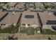 Aerial view of home featuring a backyard patio, desert landscaping, and rooftop solar panels at 1775 E Tangelo Pl, Queen Creek, AZ 85140