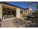 Well-maintained backyard patio featuring outdoor dining area, shade and open access to the indoors at 1775 E Tangelo Pl, Queen Creek, AZ 85140