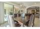 Light-filled dining room features a large wood table and chairs with access to the outdoor patio at 1775 E Tangelo Pl, Queen Creek, AZ 85140
