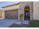 Garage exterior showing driveway and landscaped walkway to a gated entrance at 1775 E Tangelo Pl, Queen Creek, AZ 85140