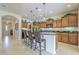 Spacious kitchen featuring a breakfast bar island, stainless steel appliances, and wooden cabinetry at 1775 E Tangelo Pl, Queen Creek, AZ 85140