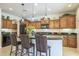 Beautiful kitchen with wooden cabinets, a stylish island, and pendant lighting at 1775 E Tangelo Pl, Queen Creek, AZ 85140