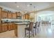 Modern kitchen with a breakfast bar, stainless steel appliances, and dark countertops at 1775 E Tangelo Pl, Queen Creek, AZ 85140