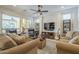 Cozy living room with plush sofas, a ceiling fan, and abundant natural light at 1775 E Tangelo Pl, Queen Creek, AZ 85140
