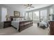 Serene primary bedroom filled with natural light, features a plush bed, and cozy sitting area at 1775 E Tangelo Pl, Queen Creek, AZ 85140