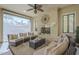 Comfortable outdoor patio featuring a fireplace and sitting area, with retractable shades for adaptable shade at 1775 E Tangelo Pl, Queen Creek, AZ 85140
