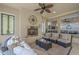 Comfortable outdoor space with ceiling fan, fireplace, ample seating area, and decorative lighting at 1775 E Tangelo Pl, Queen Creek, AZ 85140