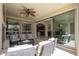 Outdoor patio with comfortable seating area, ceiling fan, and open access to the indoors at 1775 E Tangelo Pl, Queen Creek, AZ 85140