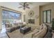 Cozy outdoor patio with comfortable seating, fireplace, and roll down shades for added privacy at 1775 E Tangelo Pl, Queen Creek, AZ 85140