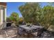Outdoor patio table and chairs set with a paver patio and landscaped yard at 1775 E Tangelo Pl, Queen Creek, AZ 85140