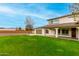 Backyard featuring a lush lawn and covered patio perfect for outdoor entertaining and relaxation at 18621 W Missouri Ave, Litchfield Park, AZ 85340