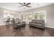 Open-concept living area with wood floors, plush sofas, and views into the kitchen at 18621 W Missouri Ave, Litchfield Park, AZ 85340