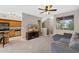 Open-concept living room featuring a neutral color palette, ceiling fan, and large windows at 1920 E Bell Rd # 1019, Phoenix, AZ 85022