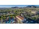 Scenic aerial perspective of community pools, buildings and lush greenery, set against a mountain backdrop at 20728 W Legend Trl, Buckeye, AZ 85396