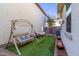 The serene backyard features a swing, artificial grass, and a cozy hammock for ultimate relaxation and outdoor enjoyment at 20728 W Legend Trl, Buckeye, AZ 85396