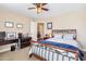 Cozy bedroom featuring a ceiling fan, wood furniture and light tan walls at 20728 W Legend Trl, Buckeye, AZ 85396
