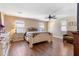 Spacious bedroom featuring wood floors, ceiling fan, and well lit with natural light at 20728 W Legend Trl, Buckeye, AZ 85396