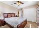 Bedroom featuring a bed with wood frame, a ceiling fan, and an armoire at 20728 W Legend Trl, Buckeye, AZ 85396