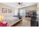 Bedroom with ceiling fan, large desk, and chair at 20728 W Legend Trl, Buckeye, AZ 85396