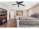 Cozy bedroom boasts ceiling fan, white dresser, and a view to other rooms at 20728 W Legend Trl, Buckeye, AZ 85396
