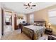 Bedroom with carpet, ceiling fan, desk and bed. Doorway leading to living room at 20728 W Legend Trl, Buckeye, AZ 85396