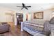 Comfortable bedroom with a fireplace and a large dresser with a painting above at 20728 W Legend Trl, Buckeye, AZ 85396
