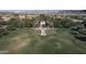 Serene aerial shot of a community green space, featuring a lush lawn and scenic walking path at 20728 W Legend Trl, Buckeye, AZ 85396