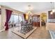 Elegant dining room with a stylish chandelier, glass-topped table, and seamless indoor/outdoor access at 20728 W Legend Trl, Buckeye, AZ 85396