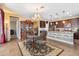 Dining room with a decorative chandelier, a display case, and a view into the kitchen at 20728 W Legend Trl, Buckeye, AZ 85396