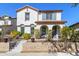 Charming two-story home with a red tile roof, stucco walls, arched entry, and landscaped front yard at 20728 W Legend Trl, Buckeye, AZ 85396