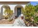 Charming front entrance with decorative potted plants framing the doorway at 20728 W Legend Trl, Buckeye, AZ 85396