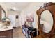 Hallway with ornate decor, books, and a painting on the wall at 20728 W Legend Trl, Buckeye, AZ 85396