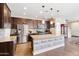 Bright kitchen with a stainless steel refrigerator and a center island with stylish wooden accents at 20728 W Legend Trl, Buckeye, AZ 85396