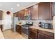 The kitchen has stainless steel appliances, a center island, granite countertops, and dark wood cabinets at 20728 W Legend Trl, Buckeye, AZ 85396