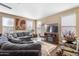 Comfortable living room featuring a large sectional sofa, stylish decor, and plenty of natural light at 20728 W Legend Trl, Buckeye, AZ 85396