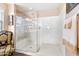 Modern glass shower with a seat and built-in shelves for bath supplies at 20728 W Legend Trl, Buckeye, AZ 85396