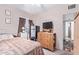 Comfortable bedroom with a wooden dresser and a view of the exterior at 2315 N 12Th St, Phoenix, AZ 85006